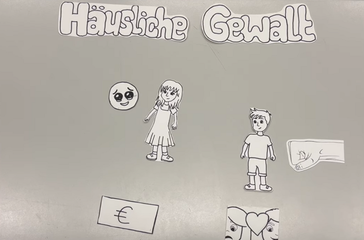 Kooperation mit dem WEISSEN RING e.V. Unter der Überschrift "Häusliche Gewalt" sind verschiedene Figuren aufgeführt, die aus Papier ausgeschnitten sind: Ein weinender Smiley neben einer Frau, eine Faust, die auf einen Mann einschlägt, das Euro-Zeichen und zwei Personen, zwischen deren Köpfe ein Herz gezeichnet ist.