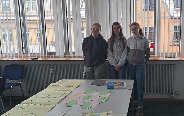 Rundum gelungene Veranstaltung in Meißen Drei weibliche Auszubildende stehen im Unterrichtsraum an der Fensterfront und posieren gut gelaunt für ein Foto.