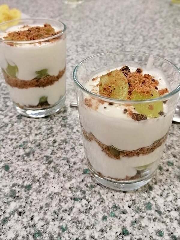 An die Töpfe, fertig, los! Zwei schön dekorierte Desserts in Gläsern, mit grünen Trauben.