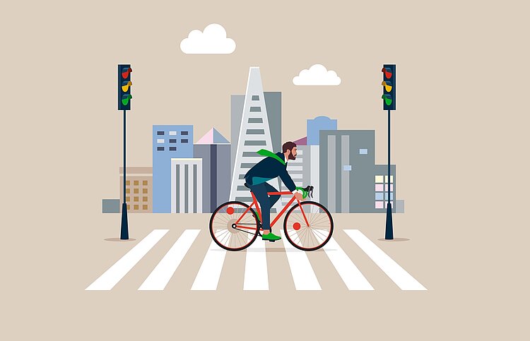 Die Illustration eines Radfahrers, der über eine Ampel in einer Stadt fährt.