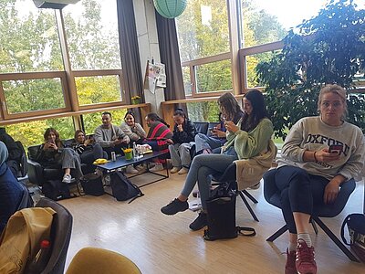 Studierende sitzen in einem Stuhlkreis in einem hellen Raum der Jugendbildungsstätte Unterfranken.