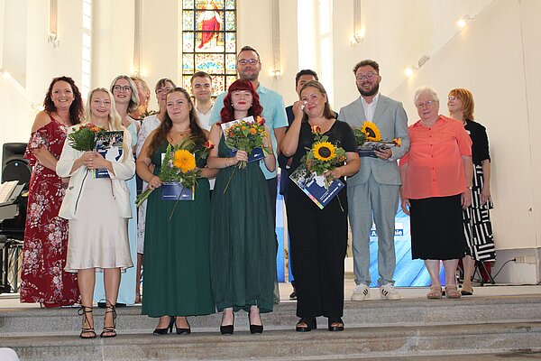 Euro Akademie Görlitz und Zittau: Feierliche Exmatrikulation Gruppenfoto der Absolvent*innen der Euro Akademie Görlitz und Zittau auf der Treppe vor dem Altar.